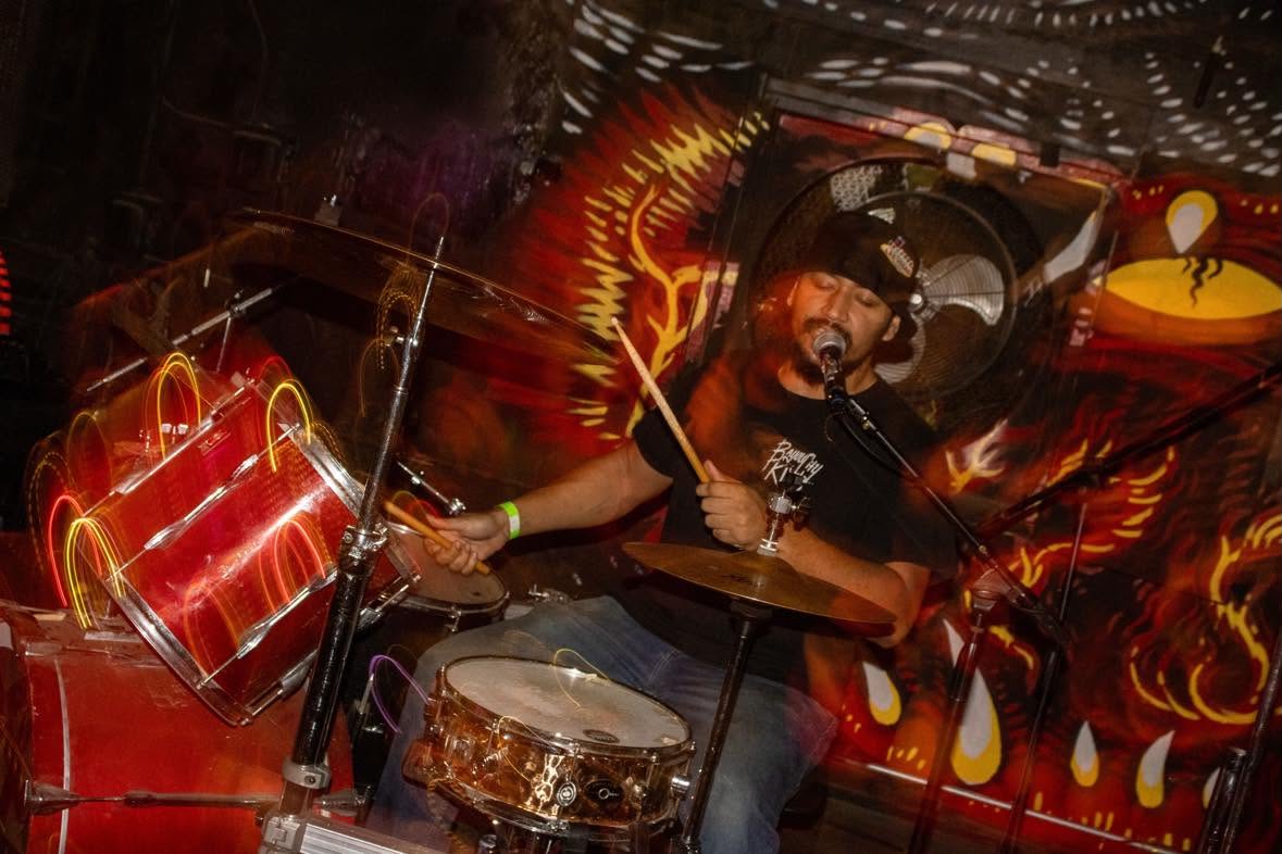 Solomon playing drums and singing live