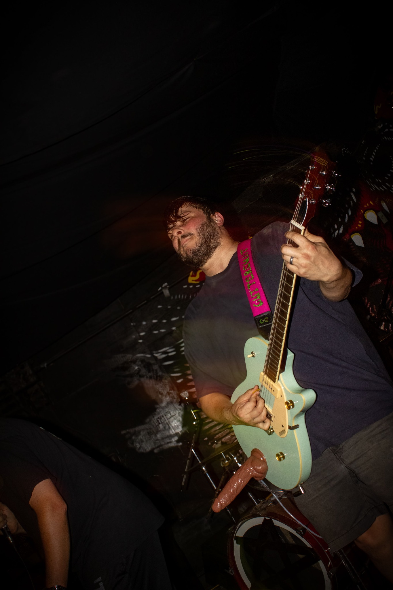 Guttercunt guitarist playing on stage